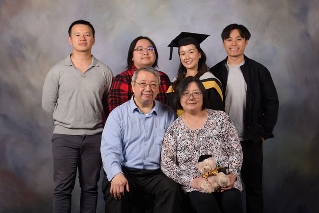 Photo of Wing and her family in a professional graduation photoshoot.